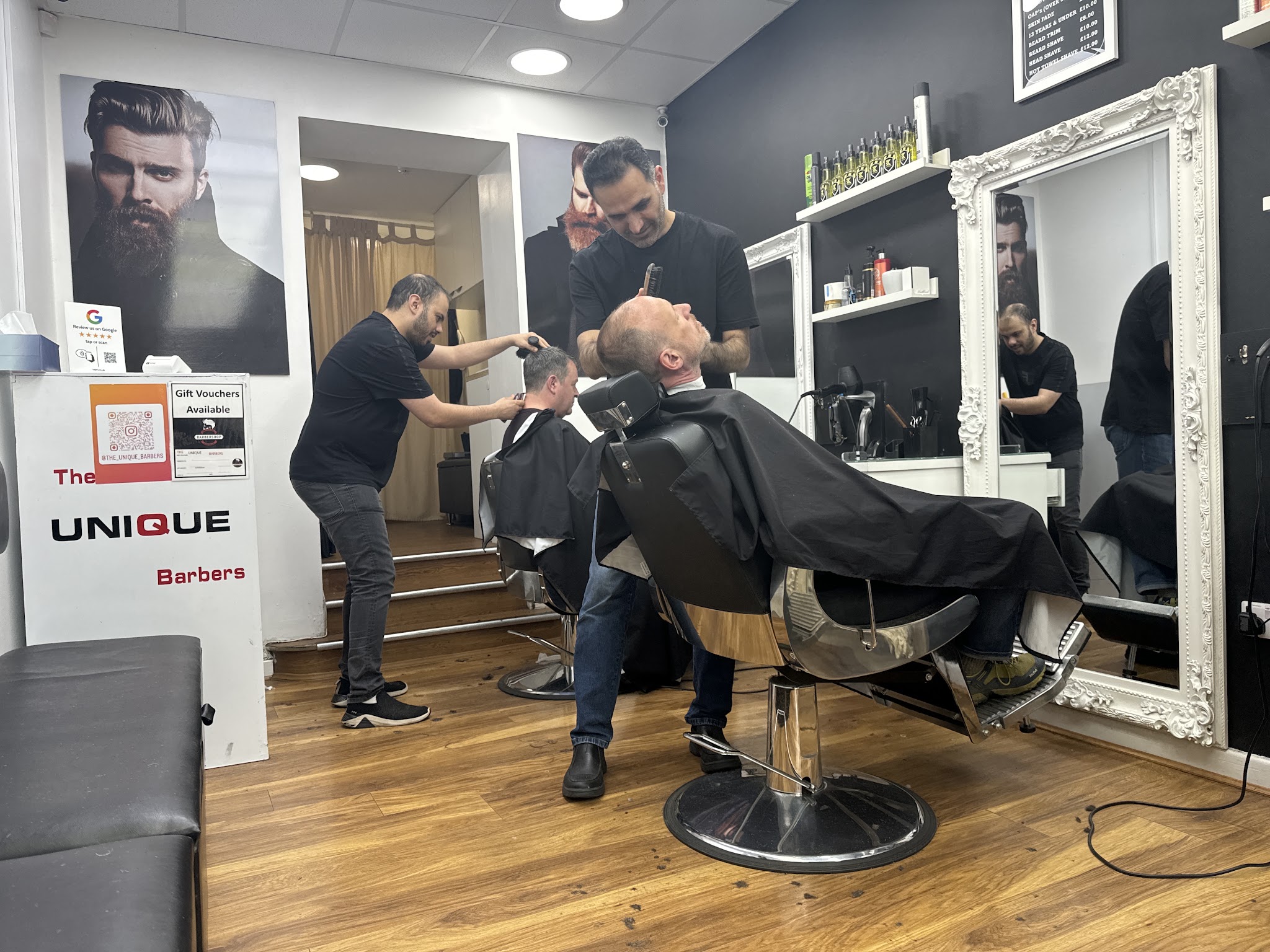The team at work cutting hair and trimming a beard in the Ilkley shop